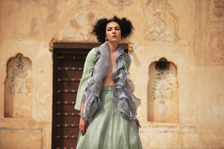 Elegant fashion portrait of a woman in traditional Indian setting.